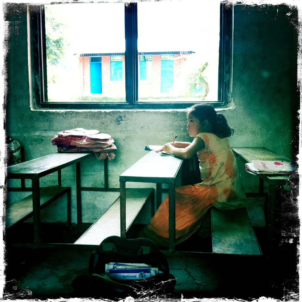 school girl in Nepal studies during recess.